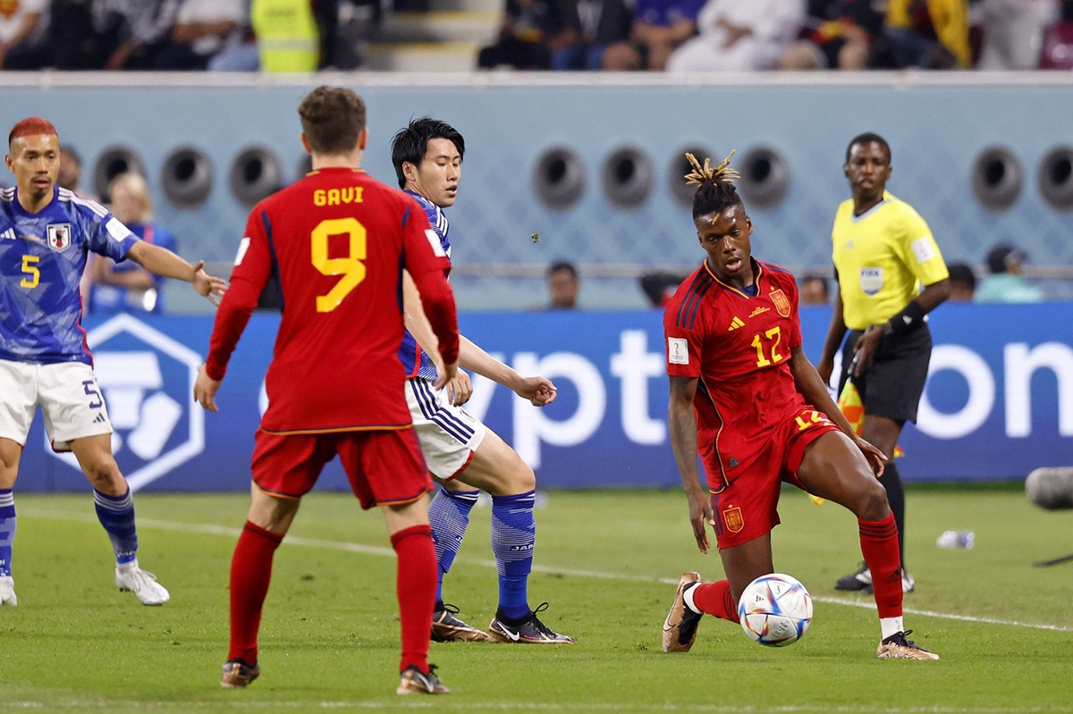 Spain forward Nico Williams (12) controls the ball against Japan during the first half of a group stage match during the 2022 World Cup at Khalifa International Stadium. 