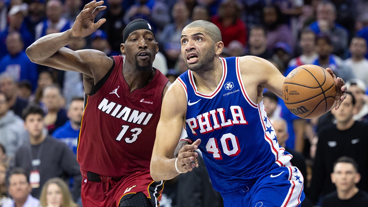 Philadelphia 76ers forward Nicolas Batum (40) drives past Miami Heat center Bam Adebayo (13) during the fourth quarter of a play-in game of the 2024 NBA playoffs at Wells Fargo Center.