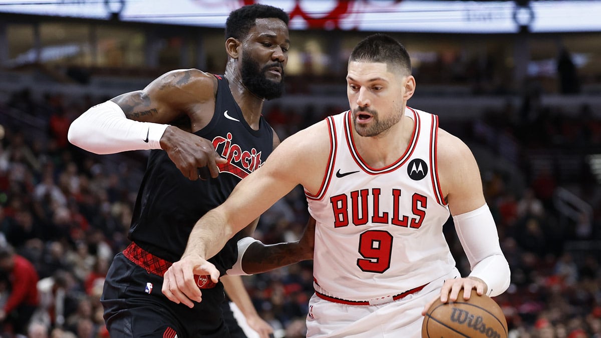 Chicago Bulls center Nikola Vucevic (9) drives to the basket against Portland Trail Blazers center Deandre Ayton (2) during the first half at United Center. 