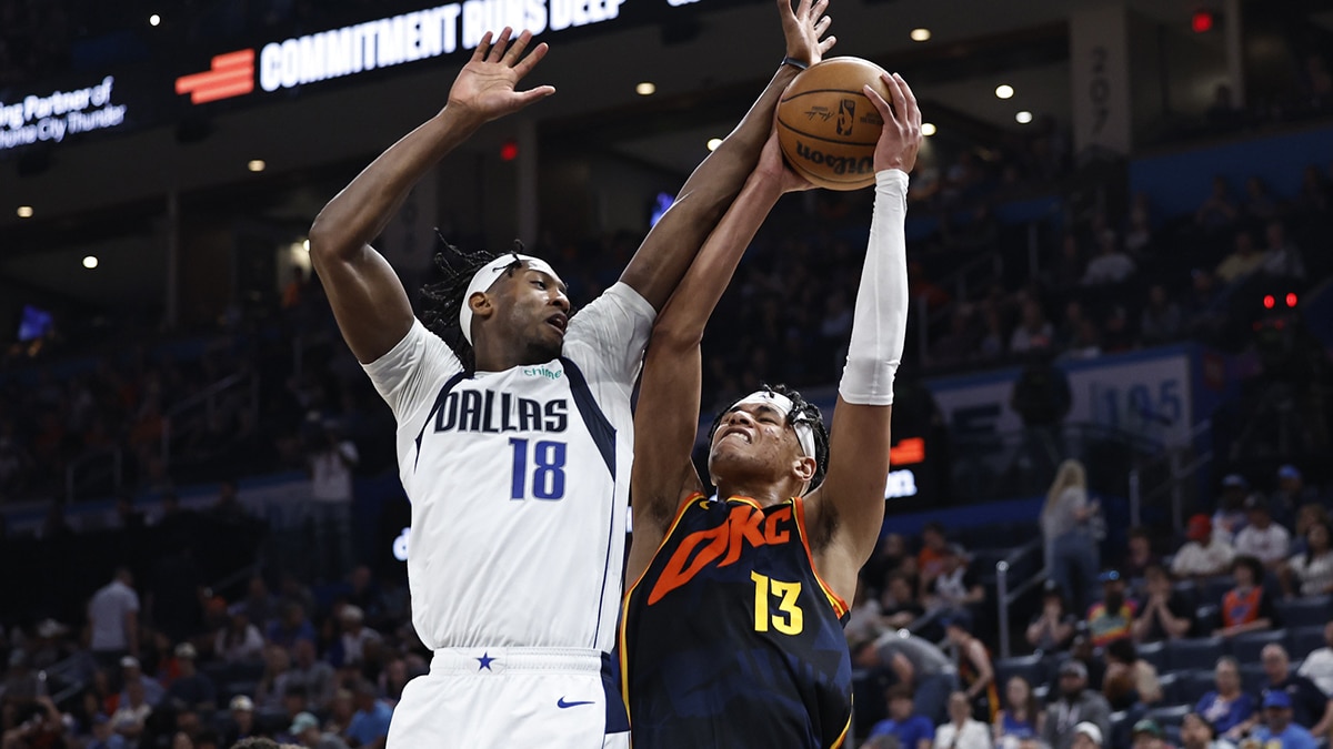 Oklahoma City Thunder forward Ousmane Dieng (13) goes up for a basket as Dallas Mavericks forward Olivier-Maxence Prosper (18) defends during the second half at Paycom Center. 