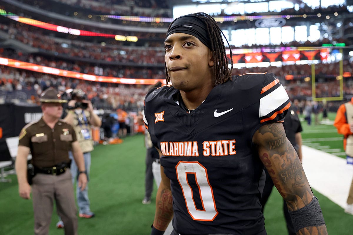 Oklahoma State's Ollie Gordon II (0) walks of the field following the Big 12 Football Championship game between the Oklahoma State University Cowboys and the Texas Longhorns at the AT&T Stadium