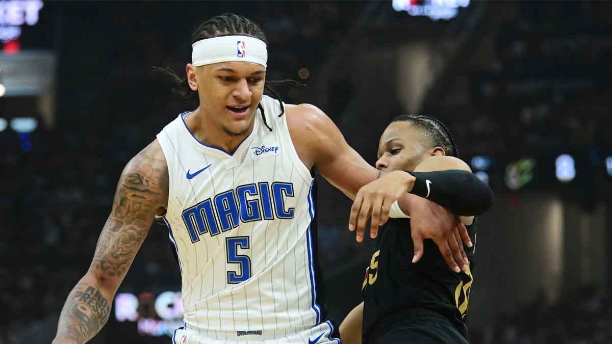 May 5, 2024; Cleveland, Ohio, USA; Orlando Magic forward Paolo Banchero (5) drives to the basket against Cleveland Cavaliers forward Isaac Okoro (35) during the first quarter of game seven of the first round for the 2024 NBA playoffs at Rocket Mortgage FieldHouse. Mandatory Credit: Ken Blaze-USA TODAY Sports