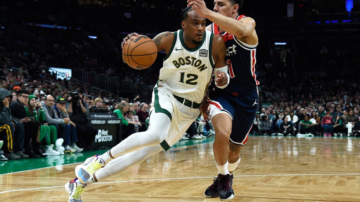 Boston Celtics forward Oshae Brissett (12) dribbles against Washington Wizards guard Johnny Davis (1) during the second half at TD Garden.