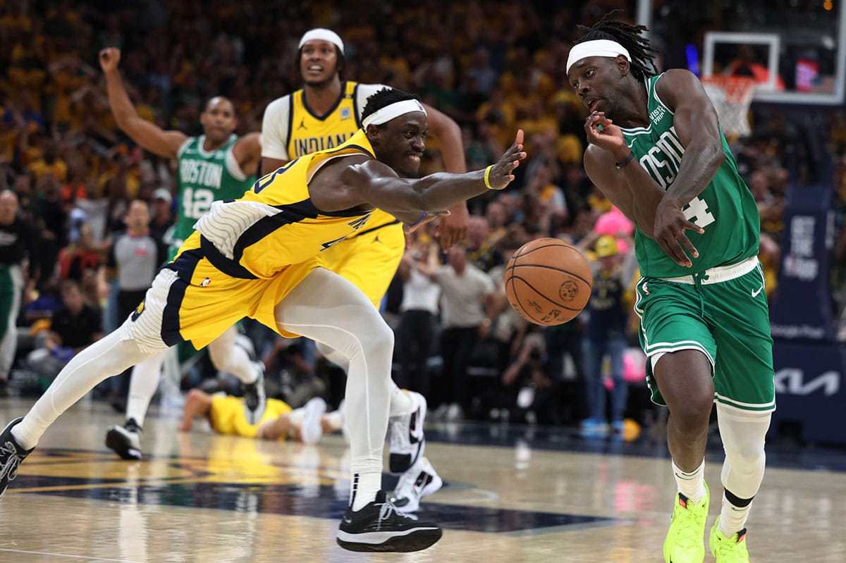 Boston Celtics guard Jrue Holiday (4) chases a loose ball against Indiana Pacers forward Pascal Siakam (43) with 1.8 seconds left in game three of the eastern conference finals in the 2024 NBA playoffs at Gainbridge Fieldhouse. 