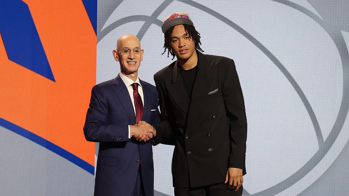 Pacome Dadiet poses for photos with NBA commissioner Adam Silver after being selected in the first round by the New York Knicks in the 2024 NBA Draft at Barclays Center.