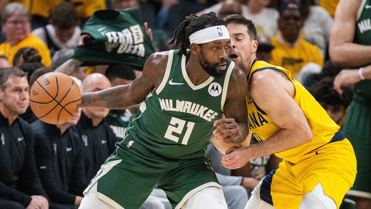 Milwaukee Bucks guard Patrick Beverley (21) dribbles the ball while Indiana Pacers guard T.J. McConnell (9) defends during game six of the first round for the 2024 NBA playoffs at Gainbridge Fieldhouse.