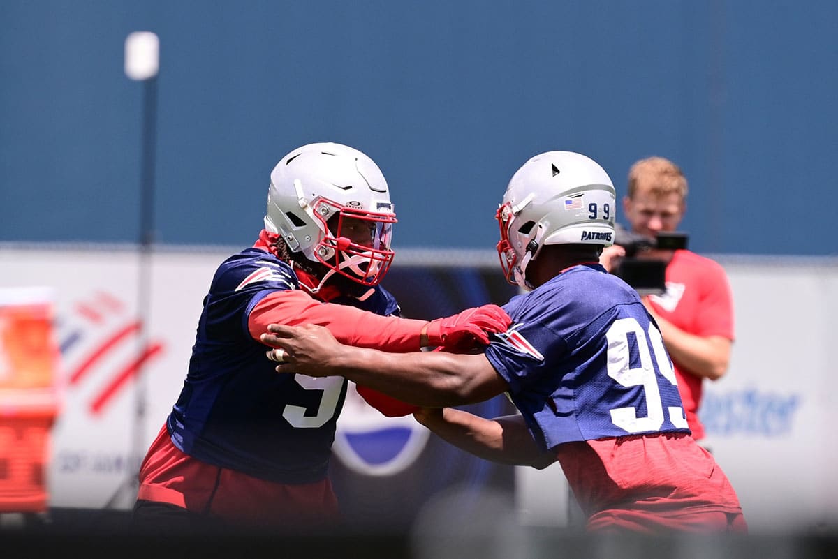 New England Patriots linebacker Matthew Judon (9) works with New England Patriots defensive end Keion White (99) at minicamp at Gillette Stadium. 
