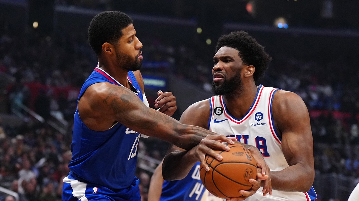 Philadelphia 76ers center Joel Embiid (21) is fouled by LA Clippers guard Paul George (13) in the first half at Crypto.com Arena.