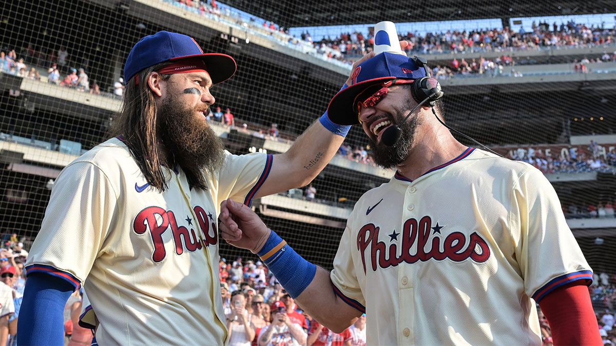 Philadelphia Phillies outfielder Brandon Marsh (16) pours water on outfielder Kyle Schwarber (12) during a post game interview after defeating the Arizona Diamondbacks at Citizens Bank Park. 