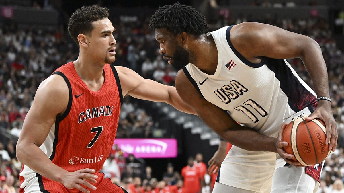 Canada forward Dwight Powell (7) guards USA forward Joel Embiid (11) in the first quarter of the USA Basketball Showcase at T-Mobile Arena.
