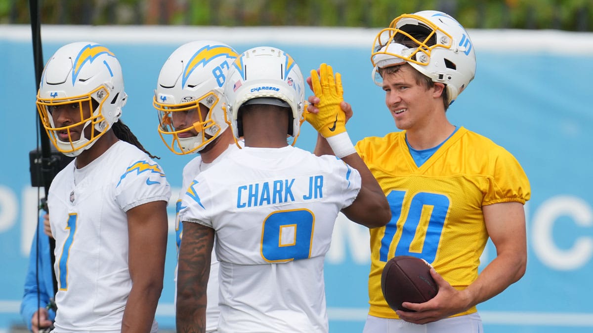 Los Angeles Chargers quarterback Justin Herbert (10) interacts with wide receivers Quentin Johnston (1), Simi Fehoko (87) and D.J. Clark (9) during minicamp at the Hoag Performance Center.