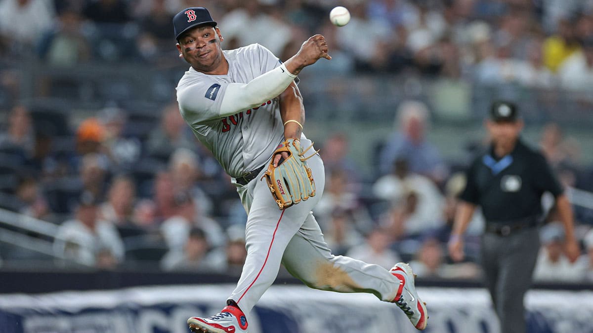 Boston Red Sox third baseman Rafael Devers (11) throws the ball to first base for an out during the eighth inning against the New York Yankees at Yankee Stadium.