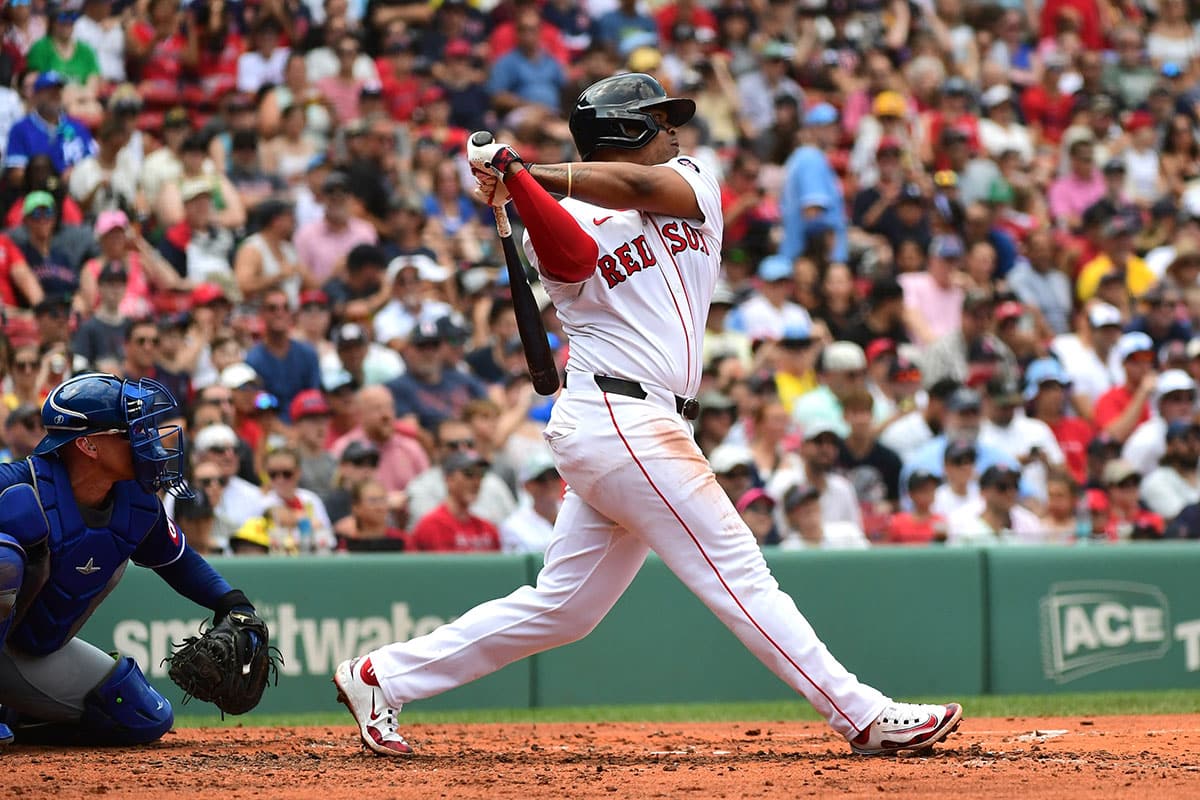 Boston Red Sox third baseman Rafael Devers (11) hits a double during the third inning against the Kansas City Royals at Fenway Park.