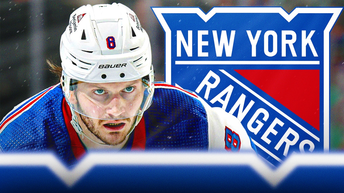 Rangers' Jacob Trouba looks at trade reporters, NHL Free Agency banner in background