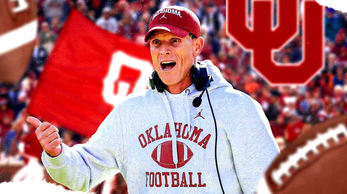 Oklahoma football coach Brent Venables, with Oklahoma players behind him.
