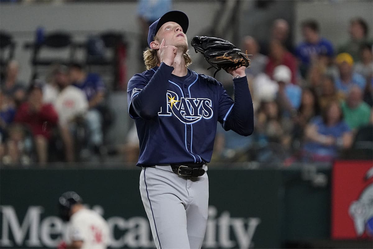 Tampa Bay Rays pitcher Shane Baz (11) points skyward as he walks off the field after pitching the fifth inning against the Texas Rangers at Globe Life Field.