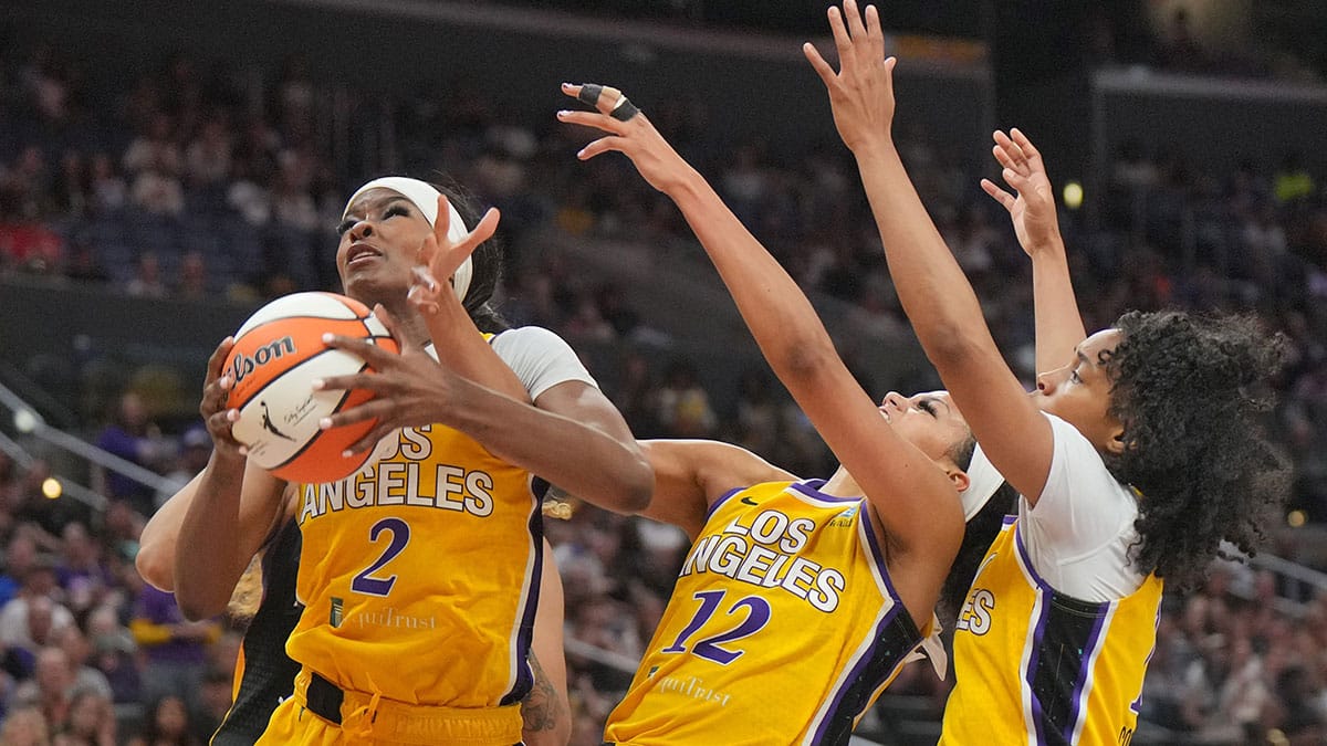 LA Sparks forward Rickea Jackson (2), guard Rae Burrell (12) and guard Zia Cooke (1) reach for the ball against the Phoenix Mercury in the second half at Crypto.com Arena.