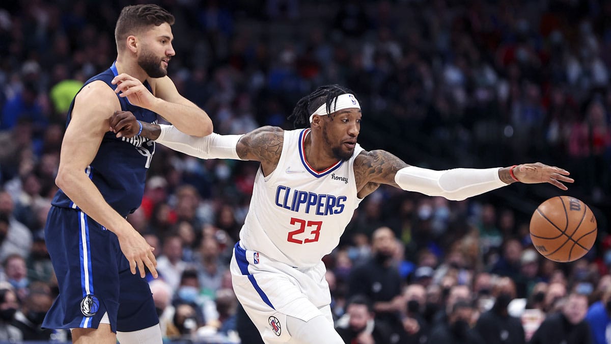 LA Clippers forward Robert Covington (23) tries to control the ball as Dallas Mavericks forward Maxi Kleber (42) defends during the second half at American Airlines Center.