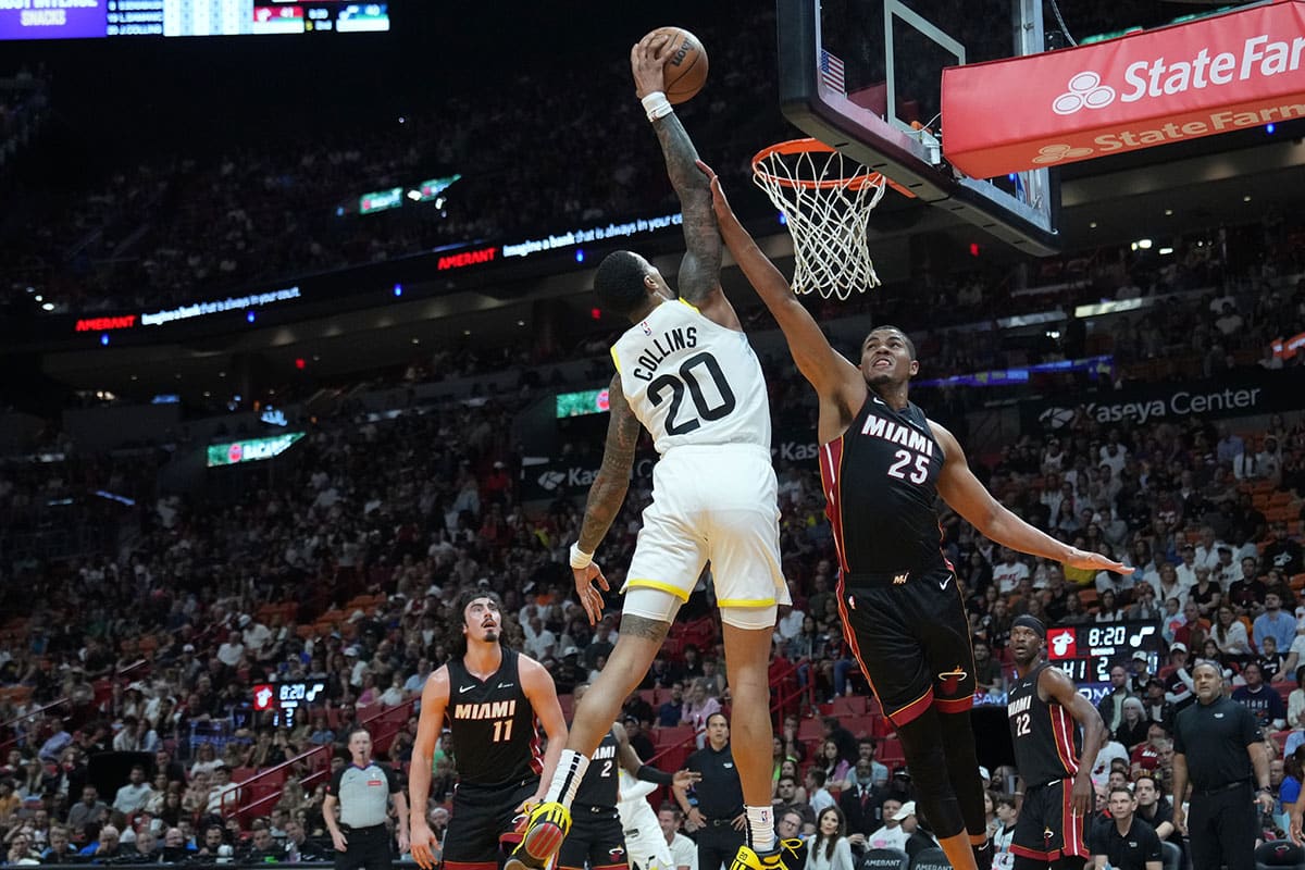 Utah Jazz forward John Collins (20) attempt a dunk as Miami Heat center Orlando Robinson (25) defends in the first half at Kaseya Center. 