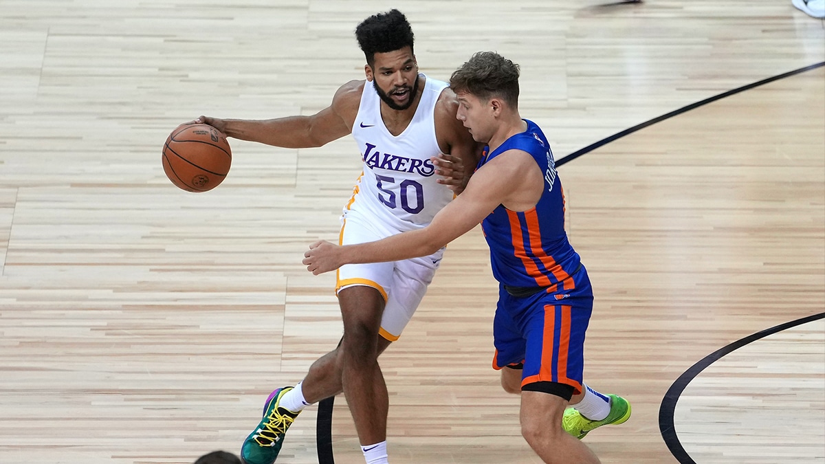 Los Angeles Lakers forward Yoeli Childs (50) dribbles against New York Knicks guard Rokas Jokubaitis (0) during an NBA Summer League game at Thomas & Mack Center.