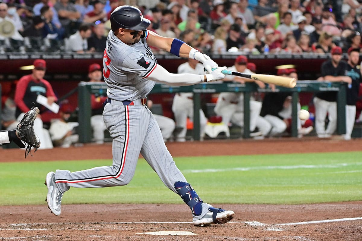 Minnesota Twins third base Royce Lewis (23) hits an RBI single in the second inning against the Arizona Diamondbacks at Chase Field.