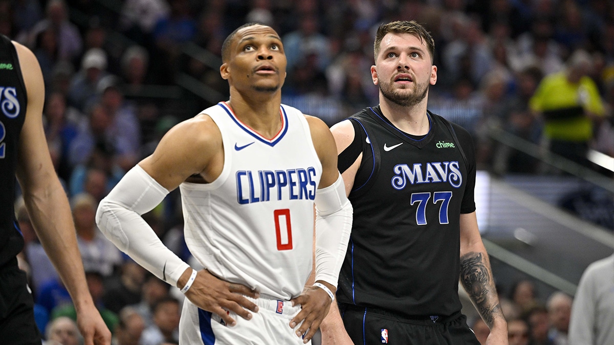 LA Clippers guard Russell Westbrook (0) and Dallas Mavericks guard Luka Doncic (77) look for the ball on a foul shot during the first quarter during game six of the first round for the 2024 NBA playoffs at American Airlines Center.