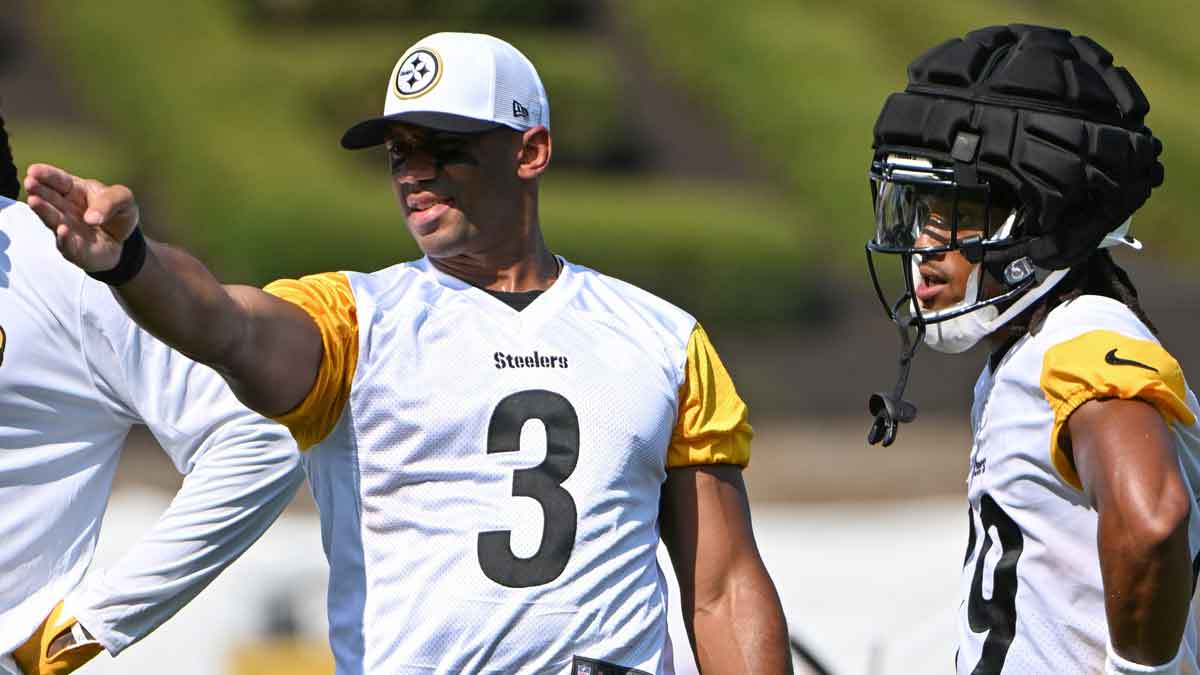 Pittsburgh Steelers quarterback Russell Wilson (3) talks to wide receiver Calvin Austin III (19) during training camp at Saint Vincent College.