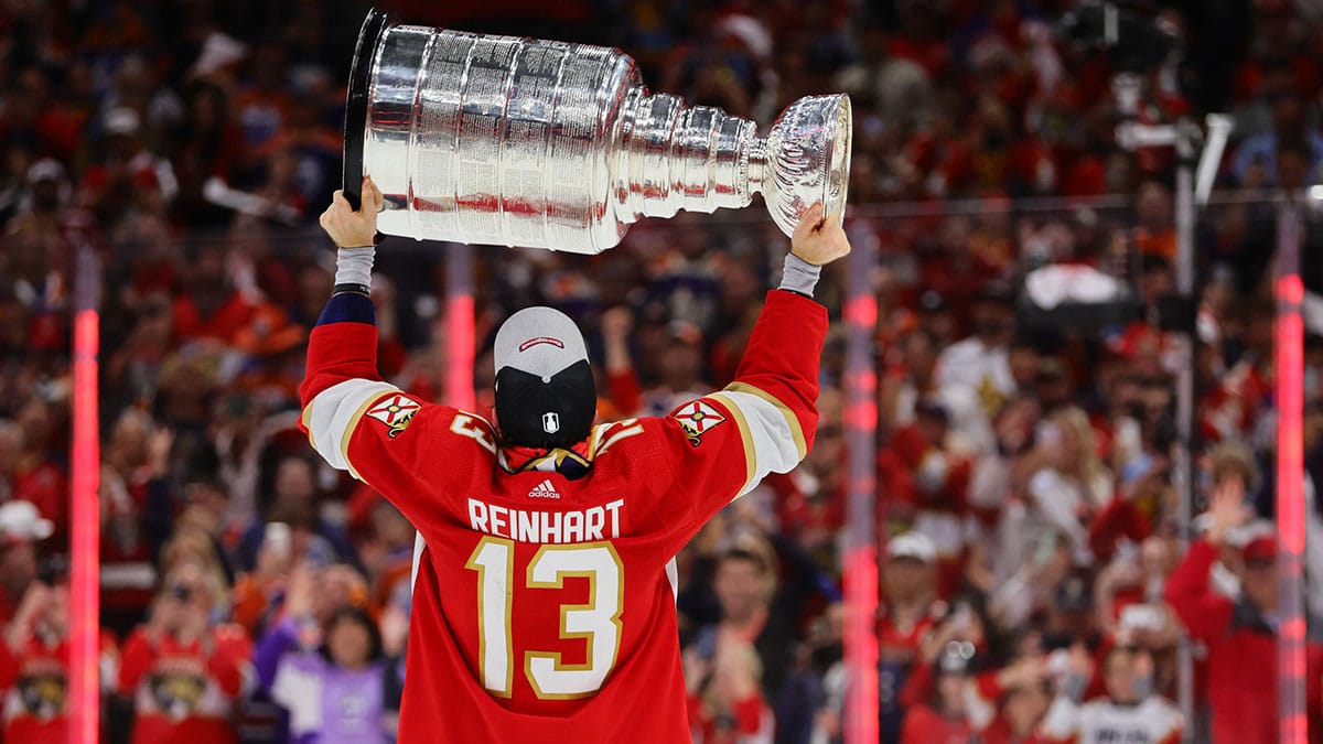 Florida Panthers center Sam Reinhart (13) lifts the cup after winning game seven of the 2024 Stanley Cup Final against the Edmonton Oilers at Amerant Bank Arena. 