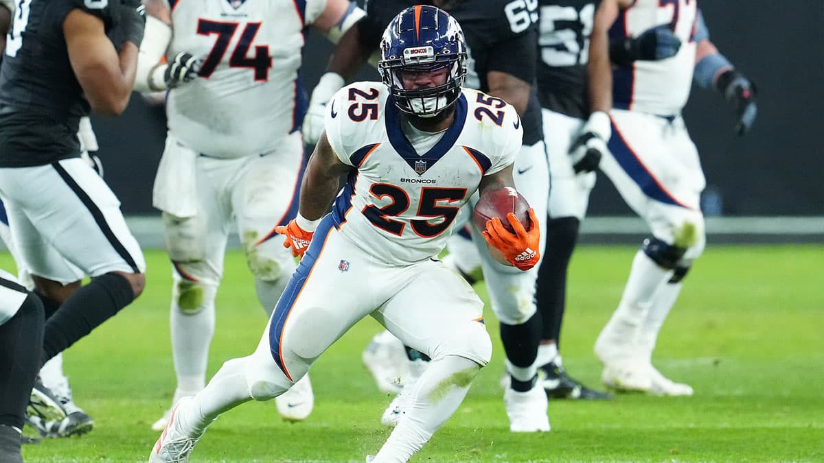 Denver Broncos running back Samaje Perine (25) gains yardage against the Las Vegas Raiders during the fourth quarter at Allegiant Stadium
