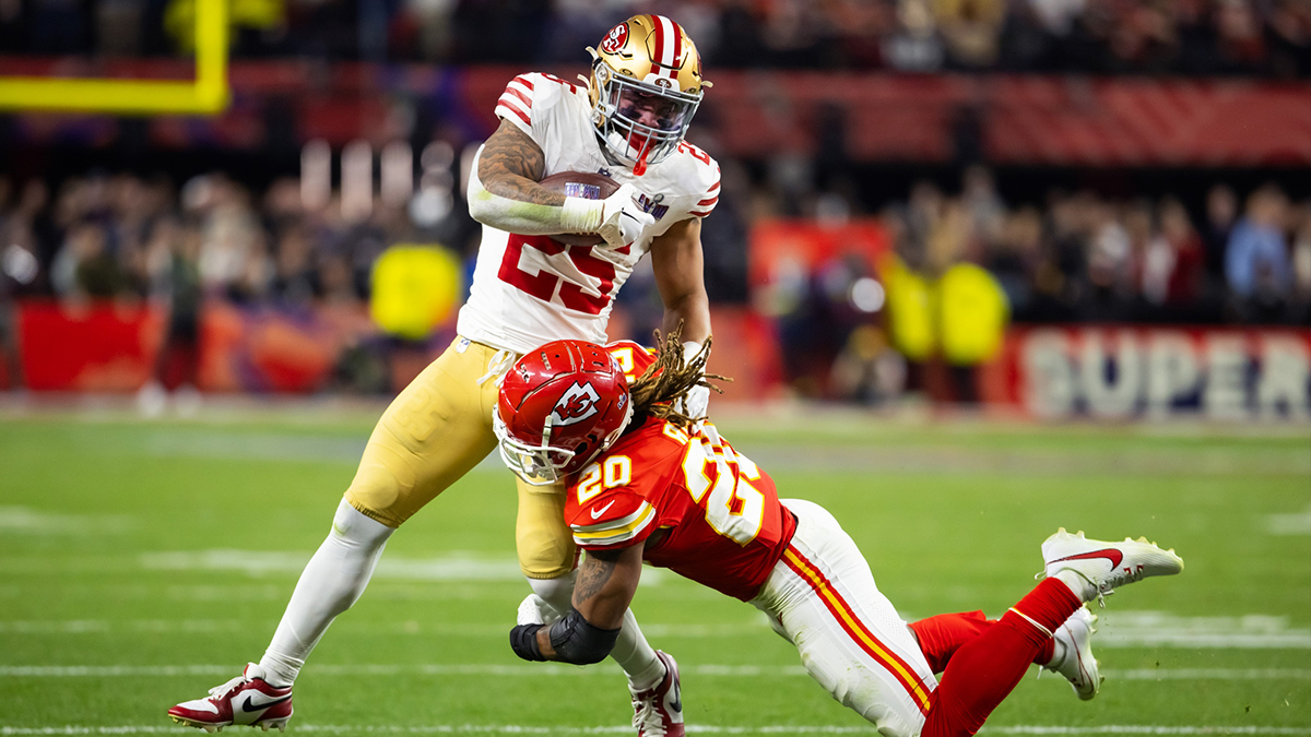 San Francisco 49ers running back Elijah Mitchell (25) is tackled by Kansas City Chiefs safety Justin Reid (20) in Super Bowl LVIII at Allegiant Stadium.