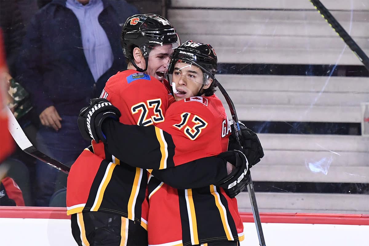 Calgary Flames left wing Johnny Gaudreau (13) celebrates with center Sean Monahan (23) after scoring a goal in the first period against the Buffalo Sabres at Scotiabank Saddledome.