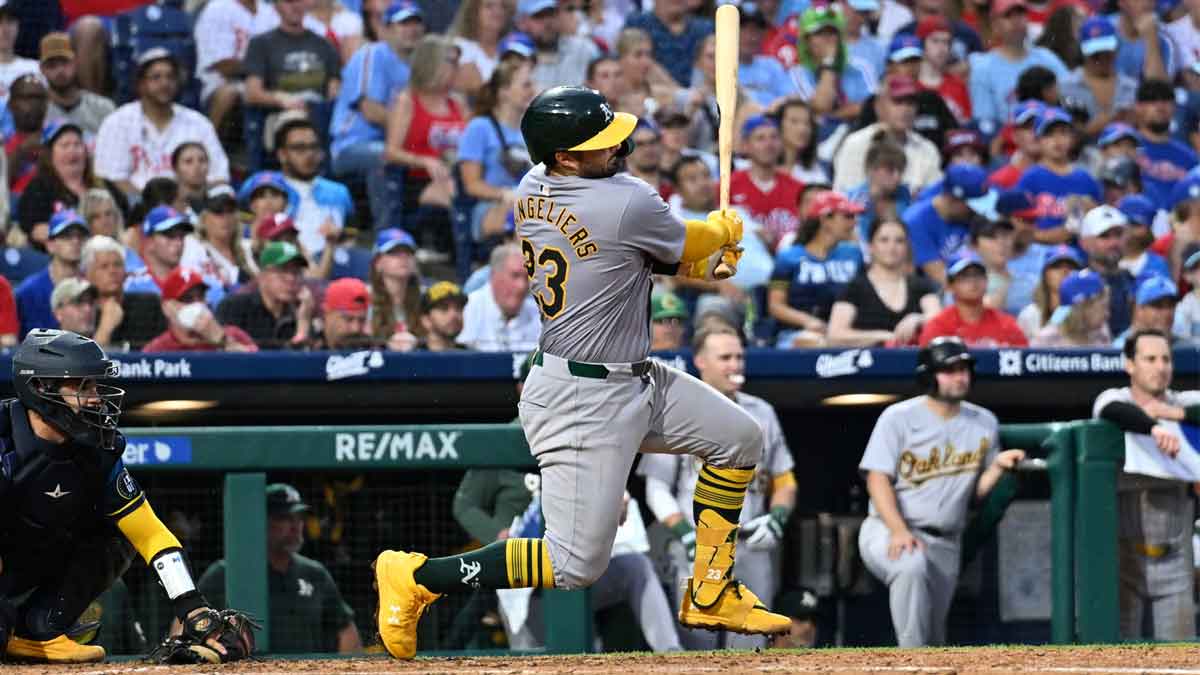 Jul 12, 2024; Philadelphia, Pennsylvania, USA; Oakland Athletics catcher Shea Langeliers (23) hits an RBI single against the Philadelphia Phillies in the fifth inning at Citizens Bank Park.