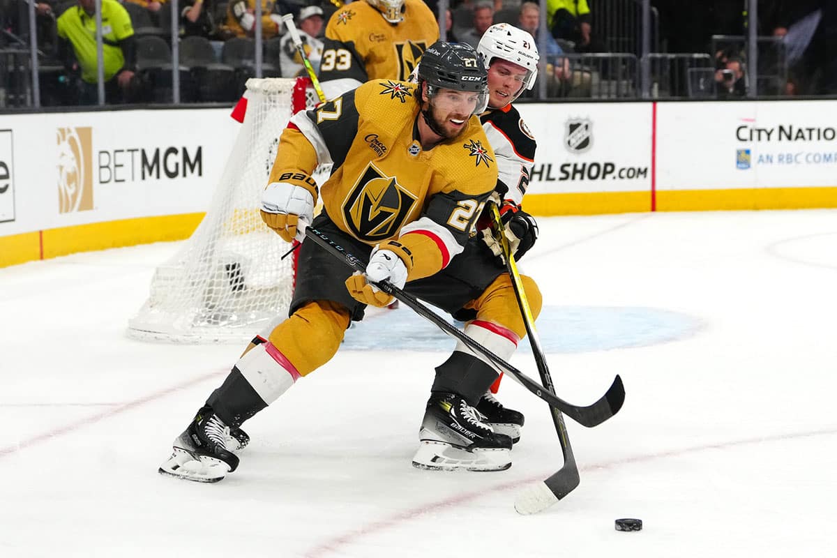 Vegas Golden Knights defenseman Shea Theodore (27) protects the puck from Anaheim Ducks center Isac Lundestrom (21) during the first period at T-Mobile Arena.