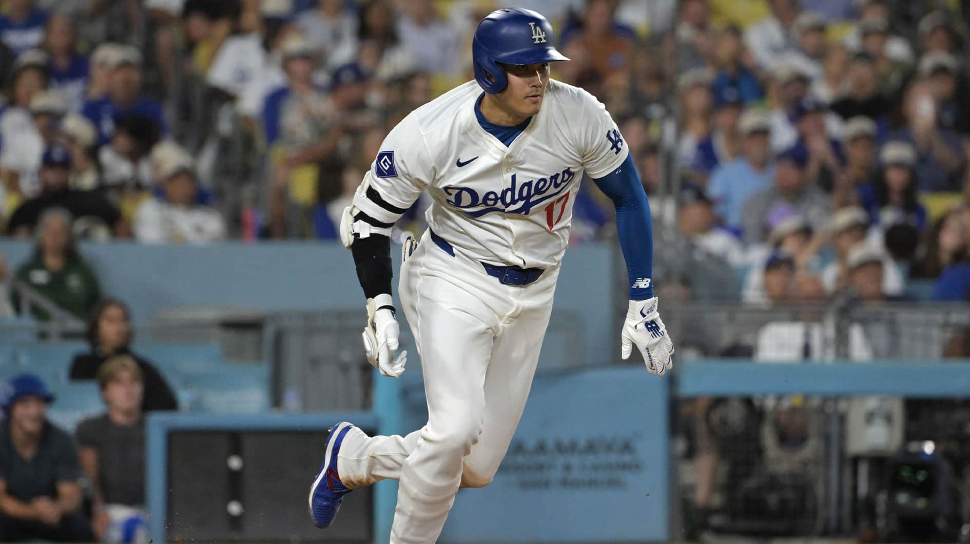 Los Angeles Dodgers designated hitter Shohei Ohtani (17) runs to first on a ground out in the sixth inning against the San Francisco Giants at Dodger Stadium. 