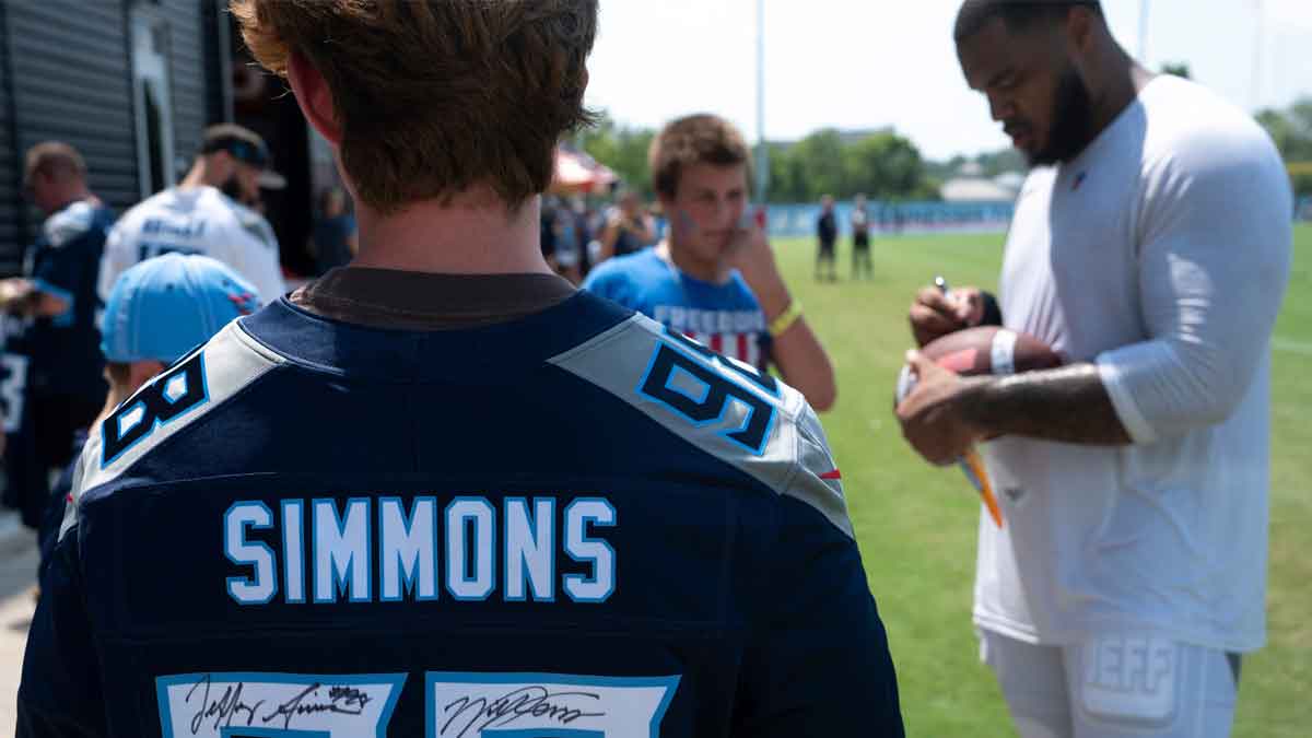Tennessee Titans defensive tackle Jeffrey Simmons (98) signs autographs after the Tennessee Titans training camp at Ascension Saint Thomas Sports Park in Nashville, Tenn., Tuesday, July 30, 2024.