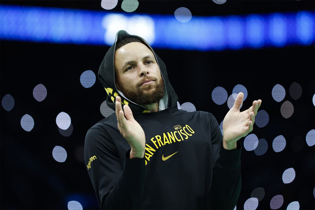 Golden State Warriors guard Stephen Curry (30) applauds during a timeout as the Warriors plays against the Charlotte Hornets during the second half at Spectrum Center.