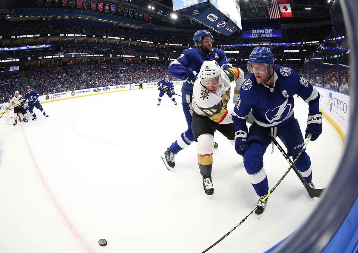 Tampa Bay Lightning center Steven Stamkos (91), Vegas Golden Knights center Jonathan Marchessault (81) and Tampa Bay Lightning defenseman Victor Hedman (77) skate after the puck during the second period at Amalie Arena.