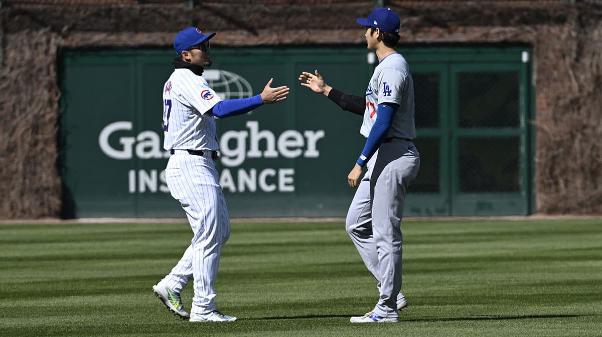Chicago Cubs outfielder Seiya Suzuki (27) and Los Angeles Dodgers two-way player Shohei Ohtani (17) talk before their teams game at Wrigley Field