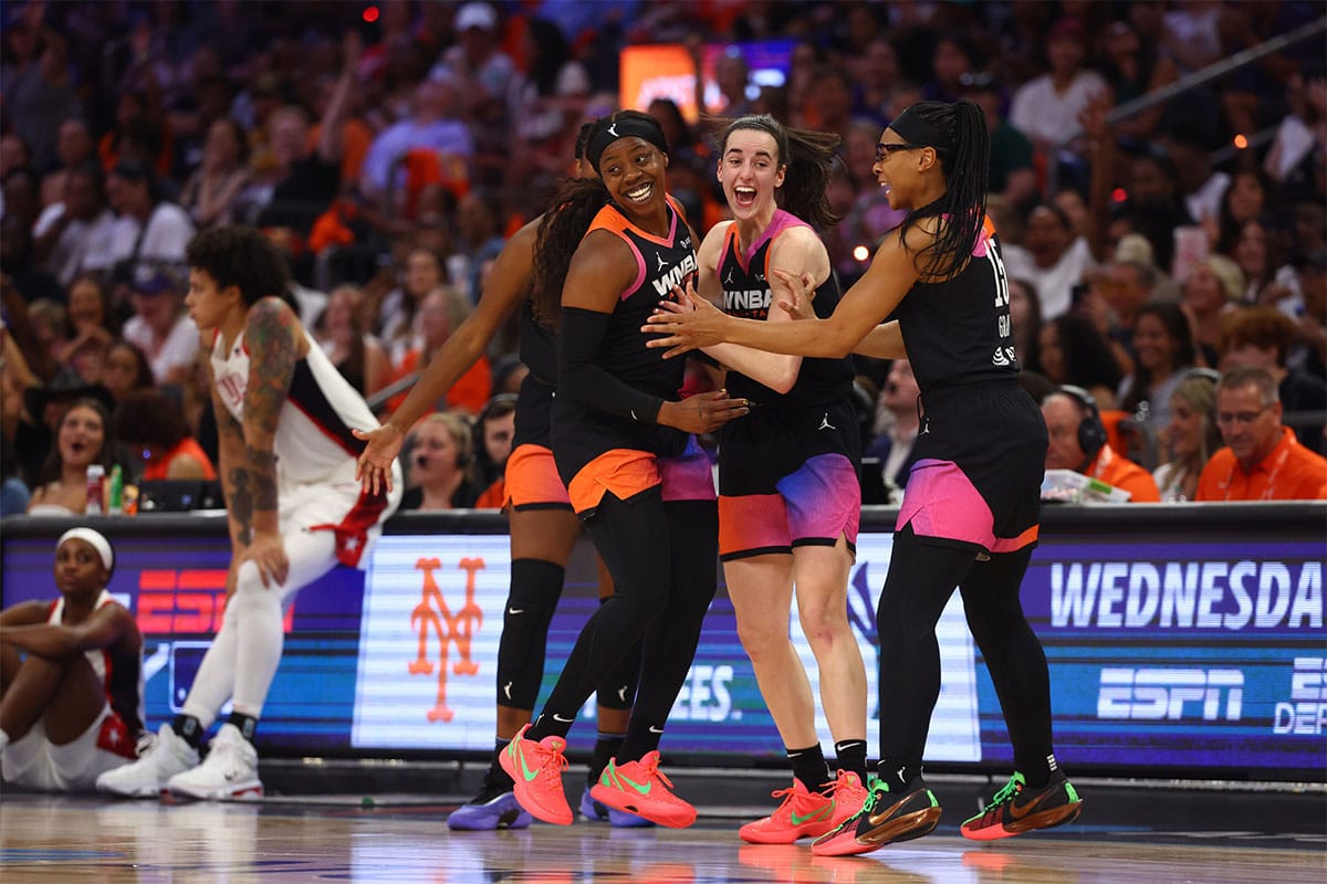 Team WNBA player Arike Ogunbowale celebrates with Caitlin Clark and Allisha Gray after making a three point shot during the second half against the USA Women's National Team