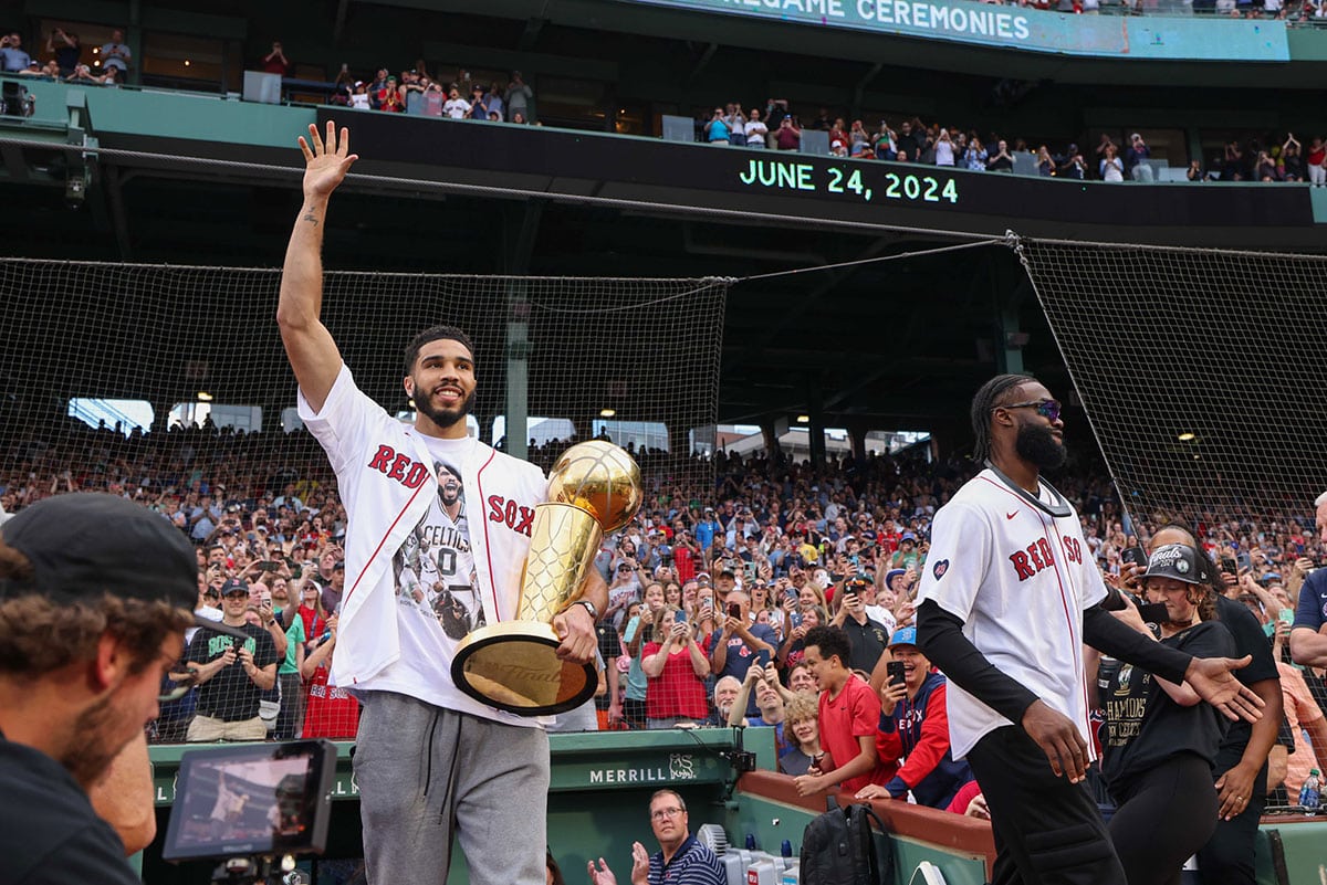 oston Celtics forward Jayson Tatum (0) walks onto the field for a pregame ceremony before a game between the Toronto Blue Jays and the Boston Red Sox at Fenway Park