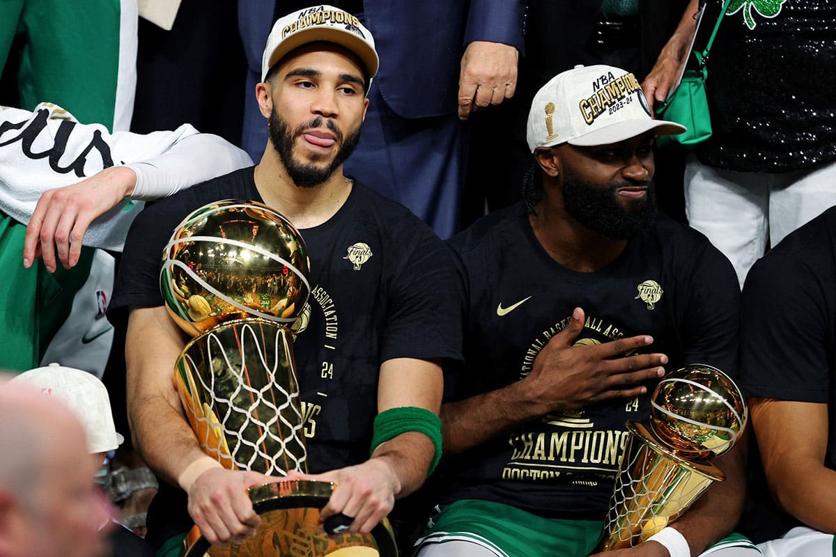  Boston Celtics forward Jayson Tatum (0) and guard Jaylen Brown (7) celebrates with the Larry O’Brian Trophy after beating the Dallas Mavericks in game five of the 2024 NBA Finals to win the NBA Championship at TD Garden.