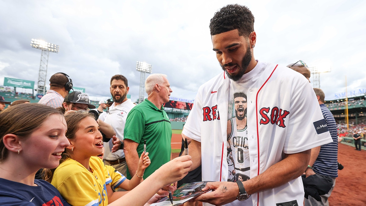 Boston Celtics forward Jayson Tatum (0) signs his autograph before a game between the Toronto Blue Jays and the Boston Red Sox at Fenway Park.