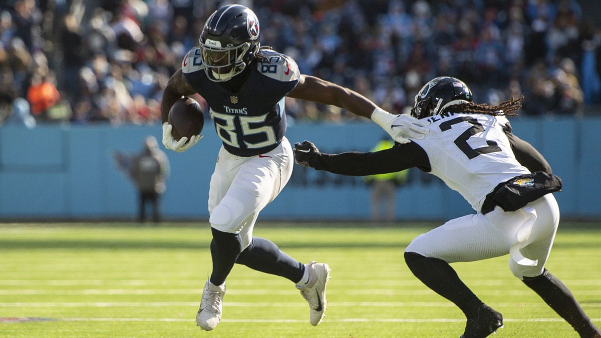 Tennessee Titans tight end Chigoziem Okonkwo (85) stiff arms Jacksonville Jaguars safety Rayshawn Jenkins (2) during the first half at Nissan Stadium. 