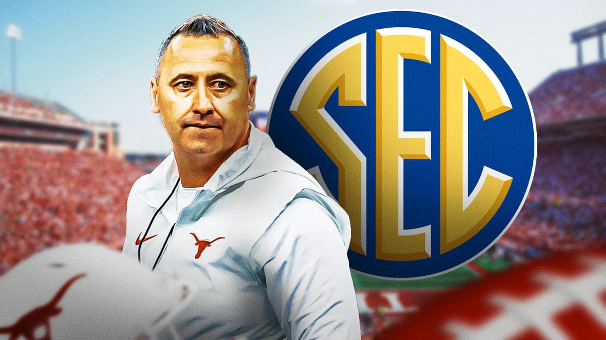 Texas football coach Steve Sarkisian looking at SEC logo.