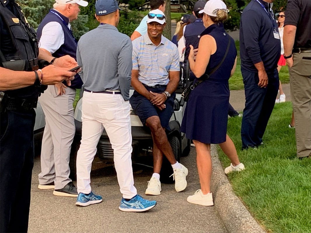 Tiger Woods poses with reporters. 