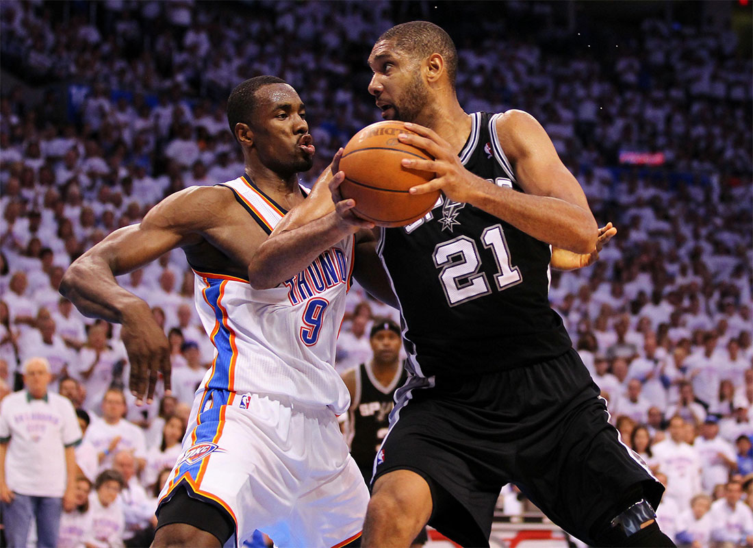 San Antonio Spurs center Tim Duncan (21) drives on Oklahoma City Thunder power forward Serge Ibaka (9) during the second half in game six of the Western Conference finals of the 2012 NBA playoffs at Chesapeake Energy Arena.
