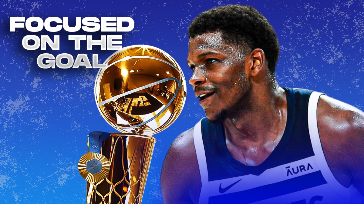 Timberwolves' Anthony Edwards smiling, with an Olympic gold medal and Larry O'Brien trophy beside him, caption below: FOCUSED ON THE GOAL