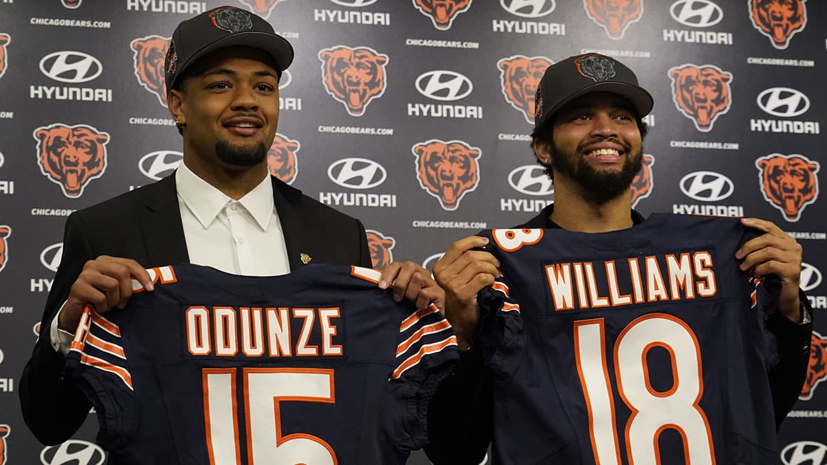Chicago Bears first round draft choices Rome Odunze (left) and Caleb Williams (right) pose for photos at a press conference at Halas Hall.