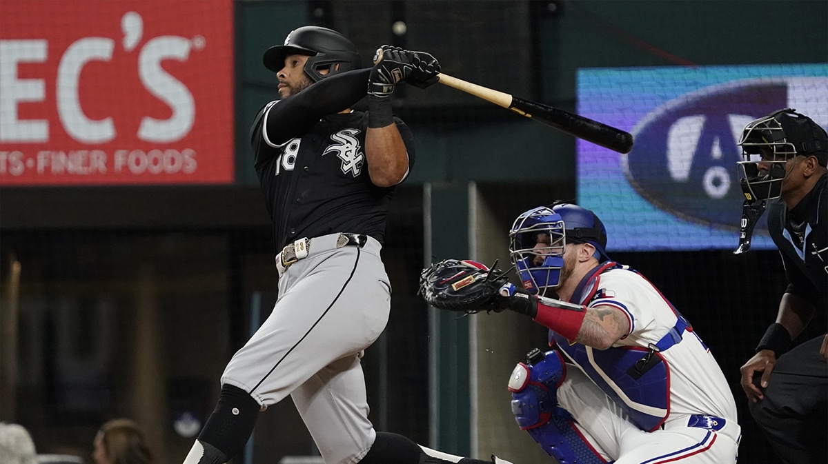 Chicago White Sox center fielder Tommy Pham (28) hits a solo home run during the first inning against the Texas Rangers at Globe Life Field.