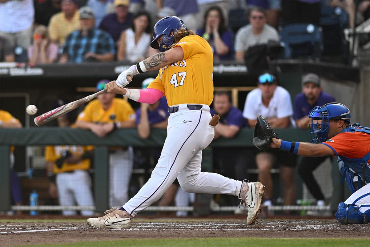 LSU Tigers third baseman Tommy White (47) hits an RBI single against the Florida Gators in the second inning at Charles Schwab Field Omaha.